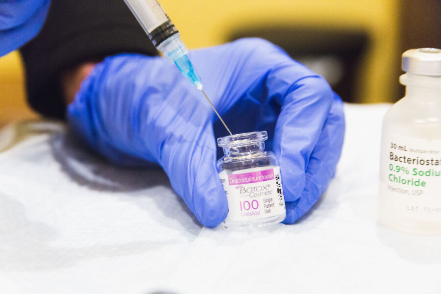 Close up of gloved hands prepping a syringe for Preventative Botox in Cincinnati