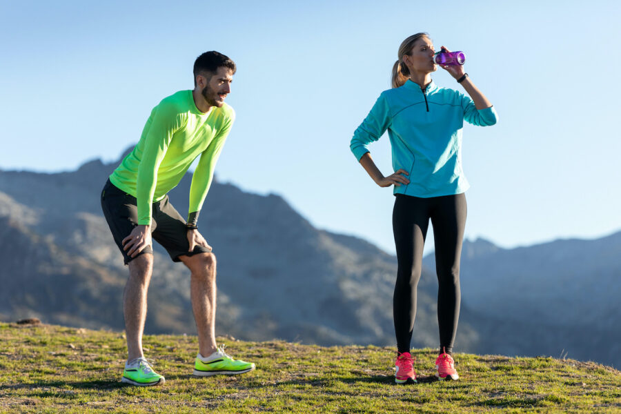 woman and man pausing for a break after running