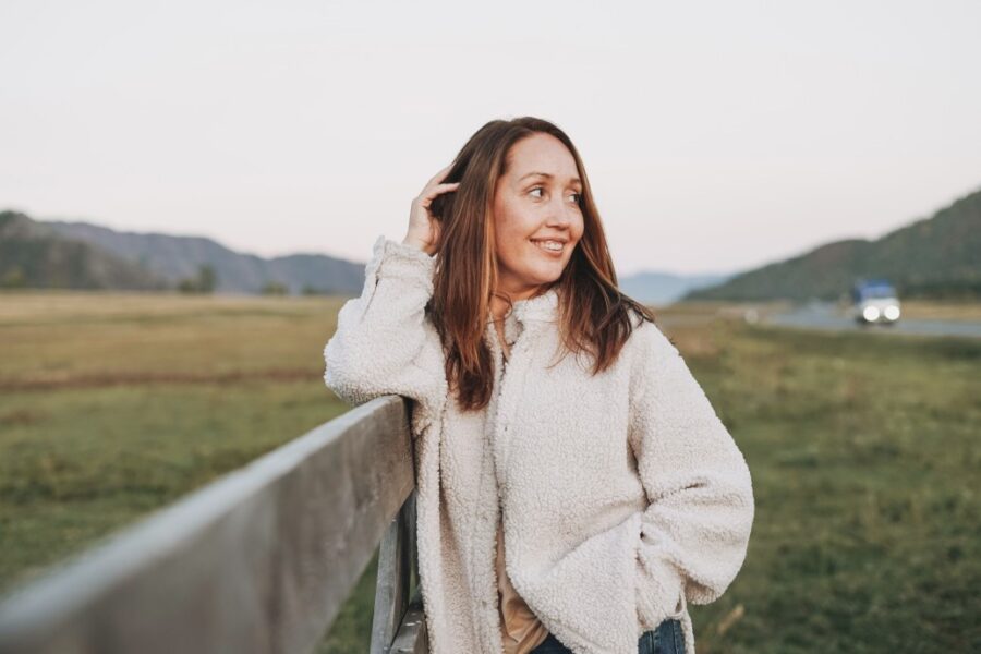 woman relaxing outside in a jacket