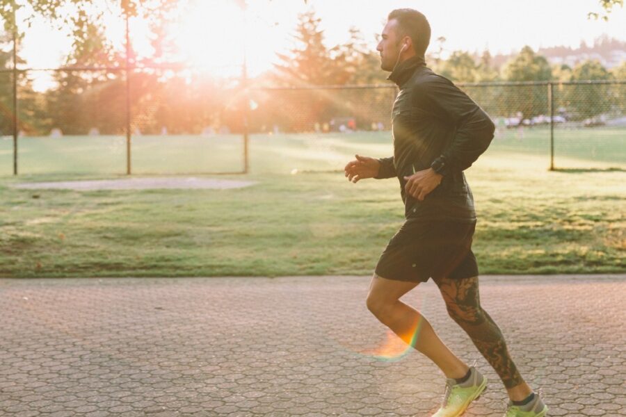 A man wondering, "how can I boost my energy levels in Cincinnati," starts to run for exercise.
