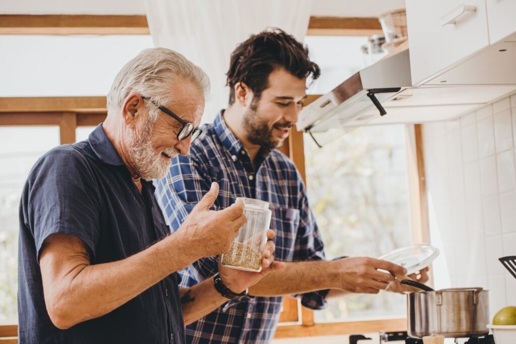father and son cooking healthy meal for weight loss in the kitchen