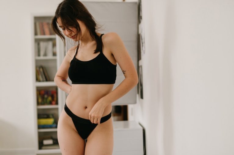 woman at home wearing black underwear set