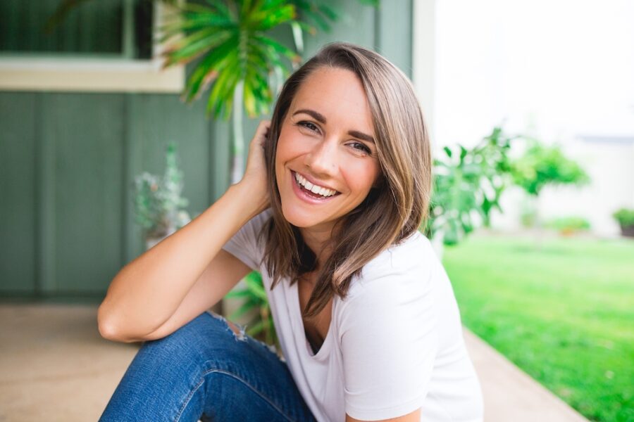 woman sitting outdoors smiling
