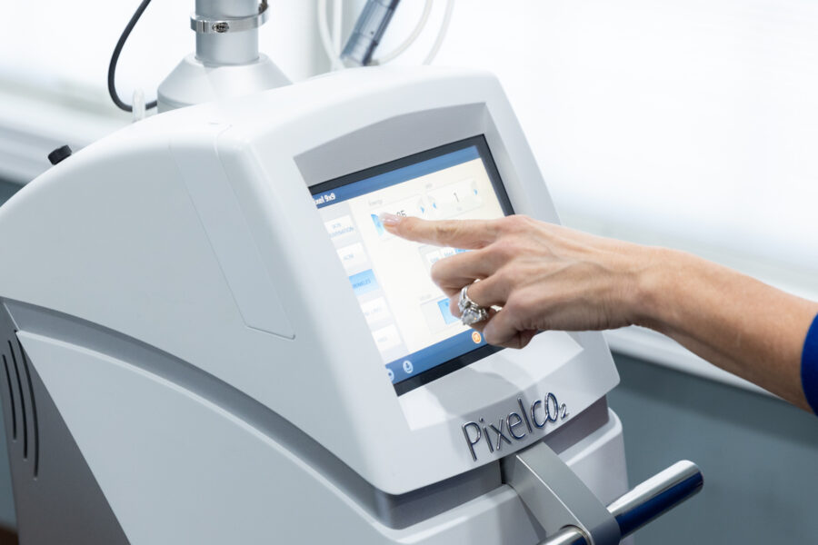 Close up of someone selecting a setting on the digital screen of a Pixel CO2 laser platform to perform spot treatment for dark spots.