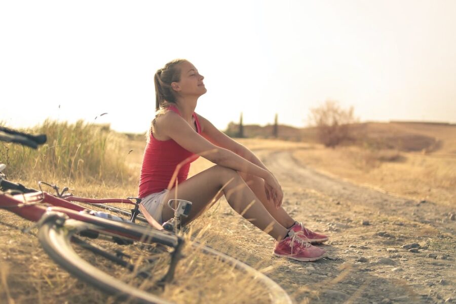 woman sitting outside after a bike ride in the sunshine