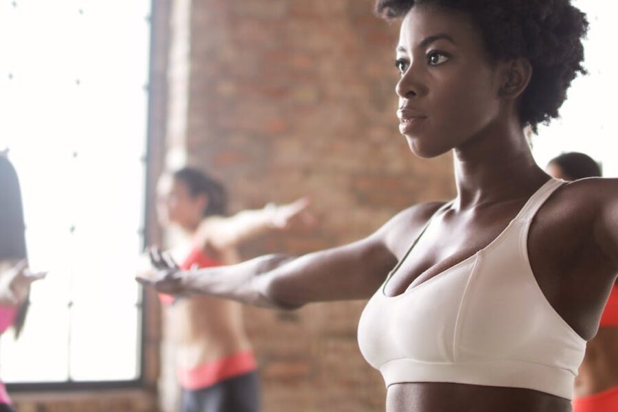 woman with her arms out side to side during an exercise class