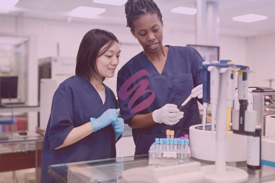 women in lab evaluating blood sample