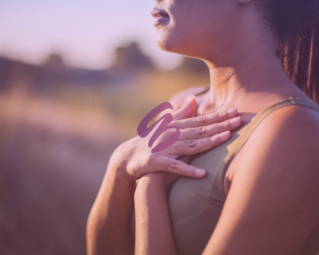 Close up of a woman holding her hands to her heart and finally feeling free after lichen sclerosus treatment near Dayton, OH.
