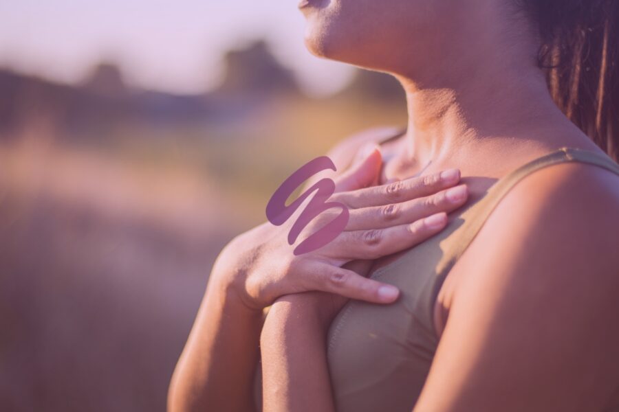 Close up of a woman holding her hands to her heart and finally feeling free after lichen sclerosus treatment near Dayton, OH.