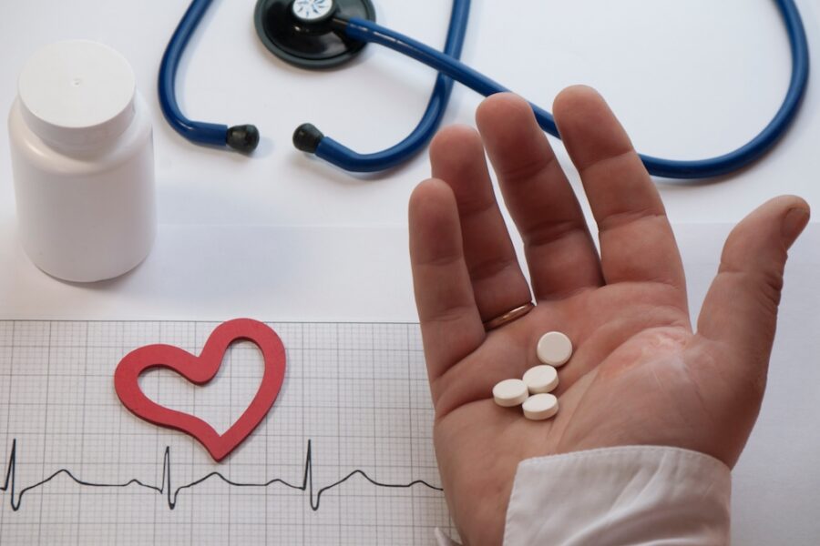 Person holding supplements for heart health in Cincinnati