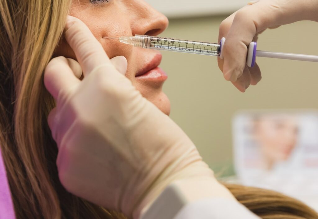 Close up of a woman receiving a cheek filler injection, one of our anti-aging injectables in Cincinnati.