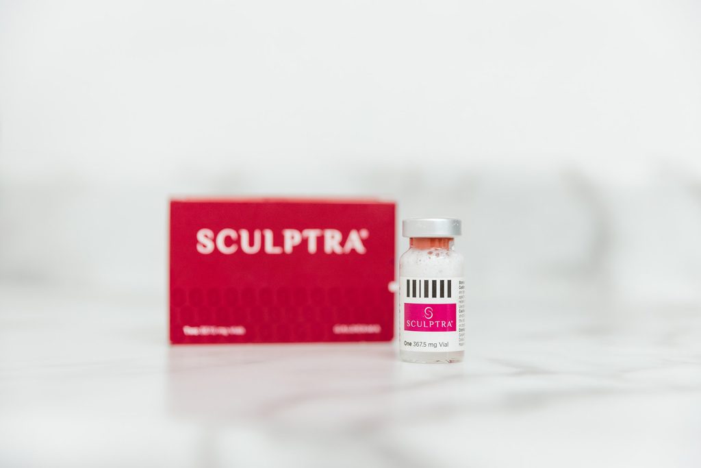 Close up of a vial of Sculptra and its box sitting on a white table, ready for a patient wanting cellulite treatment in Cincinnati.